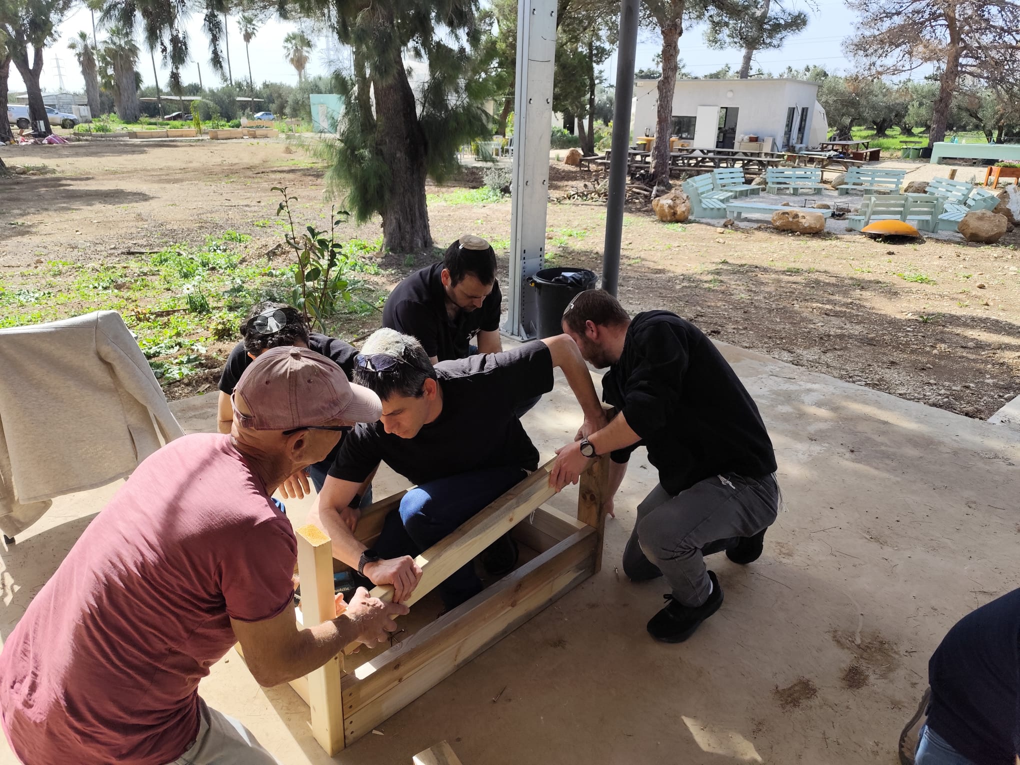 Men assembling the sides of a wooden planter box